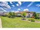 Beautiful front yard featuring lush lawn, manicured landscaping, and a charming palm tree at 4122 Natural Vista Ct, New Port Richey, FL 34655