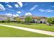 Well-maintained front yard with a lush lawn, manicured bushes, and a tidy sidewalk at 4122 Natural Vista Ct, New Port Richey, FL 34655