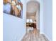 Arched hallway with wood-look tile flooring leading to living area at 4122 Natural Vista Ct, New Port Richey, FL 34655