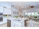 Bright, open-concept kitchen with granite counters, stainless appliances and adjoining dining and living areas at 4122 Natural Vista Ct, New Port Richey, FL 34655