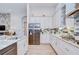 A bright kitchen showcases stainless steel appliances, granite countertops, and white cabinets at 4122 Natural Vista Ct, New Port Richey, FL 34655