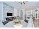 Open-concept living area with stone accent wall, and view of kitchen at 4122 Natural Vista Ct, New Port Richey, FL 34655