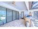Covered outdoor kitchen with stainless steel appliances, granite counters, and tile flooring at 4122 Natural Vista Ct, New Port Richey, FL 34655