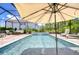 Luxurious pool area featuring a clear blue swimming pool, outdoor lounge area, and lush landscaping at 4122 Natural Vista Ct, New Port Richey, FL 34655