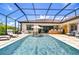 Inviting backyard pool with sun loungers and an outdoor kitchen under a screened lanai at 4122 Natural Vista Ct, New Port Richey, FL 34655