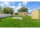 View of backyard featuring a storage shed, grassy area and privacy fence at 4242 7Th N Ave, St Petersburg, FL 33713