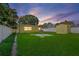 The spacious fenced backyard features a grassy area and a storage shed, perfect for outdoor activities at 4242 7Th N Ave, St Petersburg, FL 33713