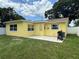 Exterior of home with large windows, patio, grill, and green grass, showcasing outdoor living at 4242 7Th N Ave, St Petersburg, FL 33713