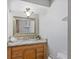 Cozy bathroom featuring a framed mirror, neutral color palette, and ample storage at 4242 7Th N Ave, St Petersburg, FL 33713