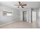 Bright bedroom features a ceiling fan, and tile floors and provides access to hallway and closet at 4242 7Th N Ave, St Petersburg, FL 33713