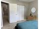 Bright bedroom featuring a closet, neutral walls, tiled floors, and a light wood dresser at 4242 7Th N Ave, St Petersburg, FL 33713