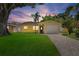 Charming single-Gathering home with a well-manicured lawn, paved driveway and attached single-car garage at 4242 7Th N Ave, St Petersburg, FL 33713