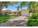 Charming yellow single Gathering home with a brick driveway and a one car garage at 4242 7Th N Ave, St Petersburg, FL 33713