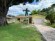 Charming yellow single-story home with a well-manicured lawn and brick driveway at 4242 7Th N Ave, St Petersburg, FL 33713