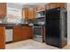 The kitchen features stainless steel appliances, tile backsplash, and wood cabinets at 4242 7Th N Ave, St Petersburg, FL 33713