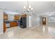 Open-concept kitchen featuring modern appliances, light tile floor, and stylish light fixtures at 4242 7Th N Ave, St Petersburg, FL 33713