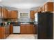 Well-equipped kitchen features wood cabinets, black countertops, and stainless steel appliances at 4242 7Th N Ave, St Petersburg, FL 33713