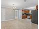 Open-concept kitchen and dining area, light tile floor, and modern light fixtures at 4242 7Th N Ave, St Petersburg, FL 33713