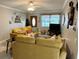 Cozy living room with comfortable yellow seating, and stylish decor at 4242 7Th N Ave, St Petersburg, FL 33713