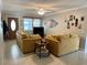 Inviting living room with comfortable seating, ceiling fan, and a light-filled ambiance at 4242 7Th N Ave, St Petersburg, FL 33713