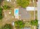 Aerial view of the home showcasing a kidney bean pool, patio, and spacious backyard at 4313 Riviera Ct, Spring Hill, FL 34608