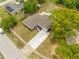 An aerial view shows the home's layout, landscaping, and spacious driveway and the surrounding neighborhood at 4313 Riviera Ct, Spring Hill, FL 34608