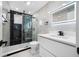 Luxurious bathroom featuring marble tile, a sleek vanity with modern fixtures, and a frameless glass shower enclosure at 4313 Riviera Ct, Spring Hill, FL 34608