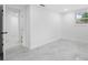 Bright, airy bedroom with marble floors, baseboard trim, white walls and natural light from the window at 4313 Riviera Ct, Spring Hill, FL 34608