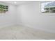 Bright, airy bedroom with two windows providing natural light, complemented by stylish tile flooring at 4313 Riviera Ct, Spring Hill, FL 34608