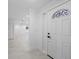 Bright foyer with marble floors, leading into an open living space and featuring a modern, decorative front door at 4313 Riviera Ct, Spring Hill, FL 34608