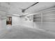 A large garage offers tons of storage space and easy home access with shelving and bright lighting at 4313 Riviera Ct, Spring Hill, FL 34608