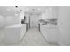 Modern kitchen with white cabinets, stainless steel appliances, tile backsplash, and a marble countertop island at 4313 Riviera Ct, Spring Hill, FL 34608