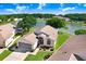 Aerial view of lakeside single-story homes nestled in a tranquil community at 4407 Whitton Way, New Port Richey, FL 34653