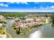 Scenic aerial view of waterfront homes in a community with lush landscaping and a tranquil lake at 4407 Whitton Way, New Port Richey, FL 34653