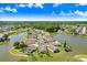 Stunning aerial view of homes nestled along a serene lake in a beautiful neighborhood at 4407 Whitton Way, New Port Richey, FL 34653