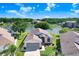 Aerial view of a charming single-story home nestled on a lake at 4407 Whitton Way, New Port Richey, FL 34653
