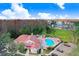 Aerial view of the community, pool, clubhouse, parking area, and the stunning surrounding landscape at 4407 Whitton Way, New Port Richey, FL 34653