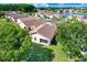 Backyard view of a home surrounded by mature trees and well-maintained greenery at 4407 Whitton Way, New Port Richey, FL 34653
