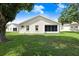 Exterior home view with a lawn and trees on a sunny day at 4407 Whitton Way, New Port Richey, FL 34653