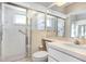 Bright bathroom featuring framed shower doors and a coordinated vanity area at 4407 Whitton Way, New Port Richey, FL 34653