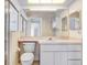 Neutral bathroom with a large vanity, an elongated toilet and a large mirror at 4407 Whitton Way, New Port Richey, FL 34653