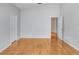 Bright, open bedroom features gleaming hardwood floors and neutral paint at 4407 Whitton Way, New Port Richey, FL 34653