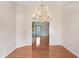 Formal dining room featuring elegant chandelier and hardwood floors at 4407 Whitton Way, New Port Richey, FL 34653