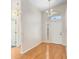 Entryway features hardwood floors, chandelier lighting, and a front door with decorative glass at 4407 Whitton Way, New Port Richey, FL 34653