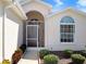Charming home entrance with a screened porch and well-manicured landscaping at 4407 Whitton Way, New Port Richey, FL 34653