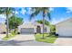 Inviting single-story home with a lush lawn and mature landscaping on a sunny day at 4407 Whitton Way, New Port Richey, FL 34653