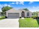 Charming single-story home with a well-maintained lawn and gray garage door at 4407 Whitton Way, New Port Richey, FL 34653
