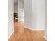Bright hallway with glossy hardwood flooring and fresh white walls at 4407 Whitton Way, New Port Richey, FL 34653