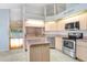 Kitchen with island, stainless steel appliances, and view to backyard at 4407 Whitton Way, New Port Richey, FL 34653