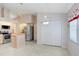 Kitchen with stainless steel refrigerator, island, and casual dining area at 4407 Whitton Way, New Port Richey, FL 34653